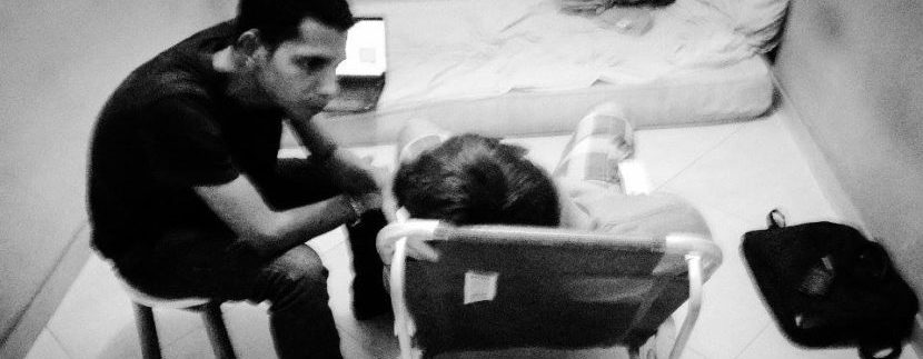 Israel Costa atendendo um paciente em casa